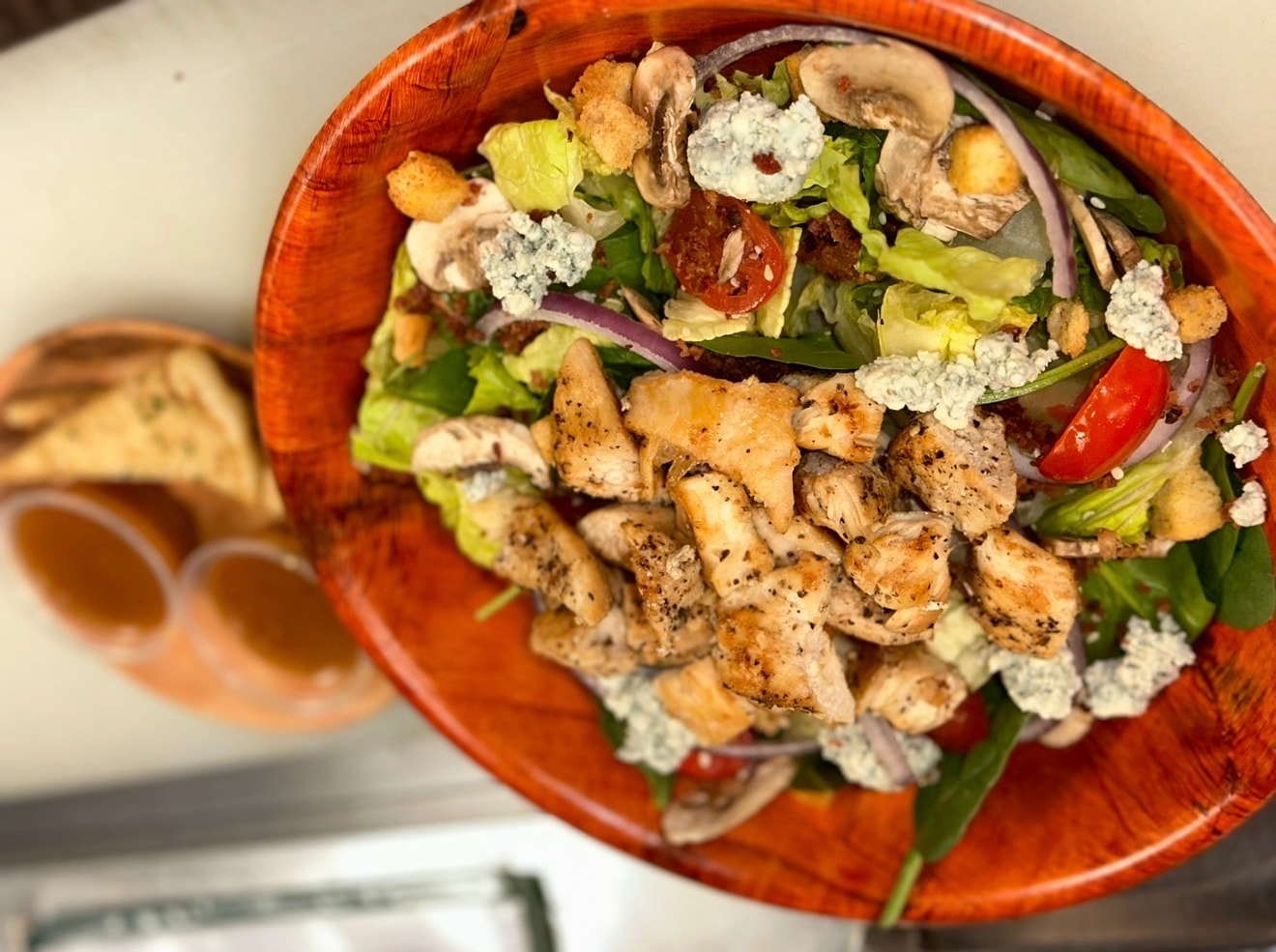 Eatz Grill grilled chicken salad with greens, mushrooms, tomatoes, red onion, croutons, and blue cheese