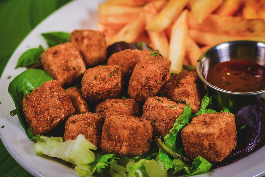 Eatz Grill crispy fried vegetable bites with fries, greens, lime, and dipping sauce